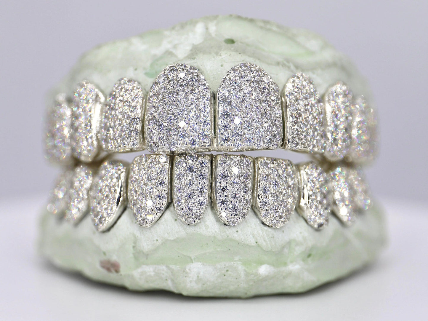 Diamond-studded custom dental grill on a neutral background
