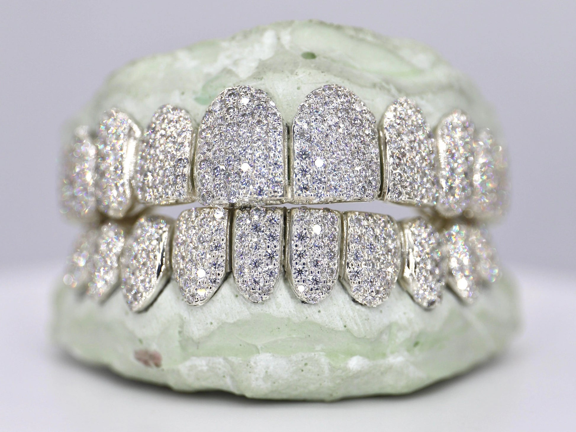 Diamond-studded dental grill on a neutral background