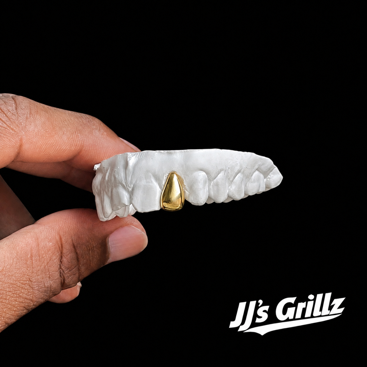 Custom gold tooth cap on dental mould by JJ’s Grillz UK