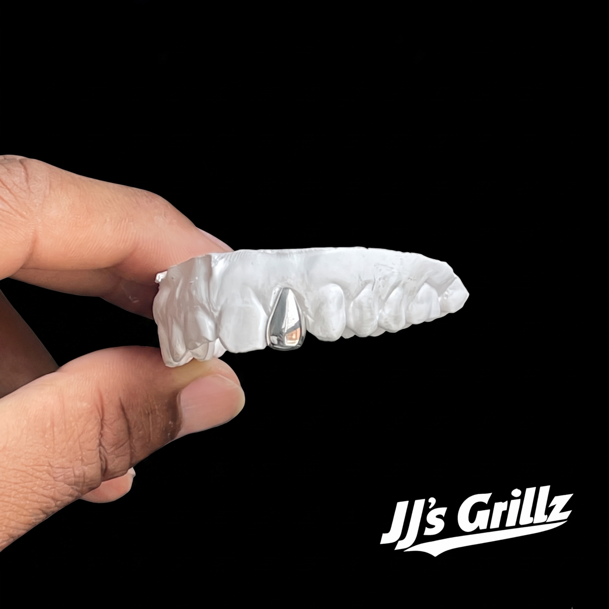 Custom silver tooth cap on dental mould by JJ’s Grillz UK