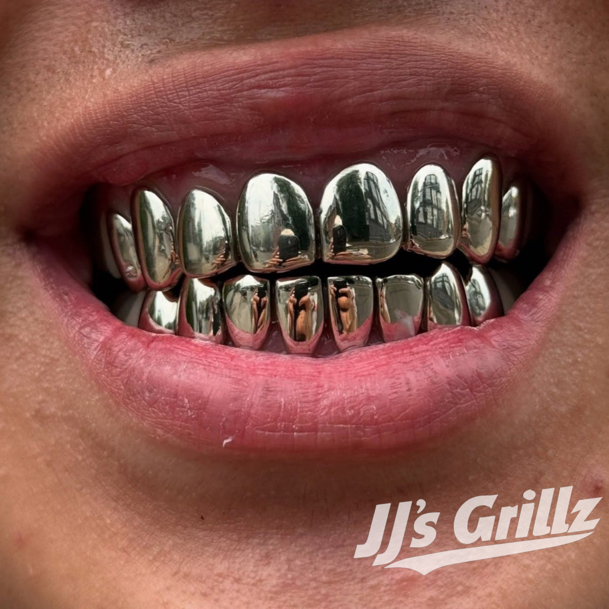 JJ’s Grillz 925 silver grillz custom-fitted to a customer’s teeth, showcasing the finished grillz