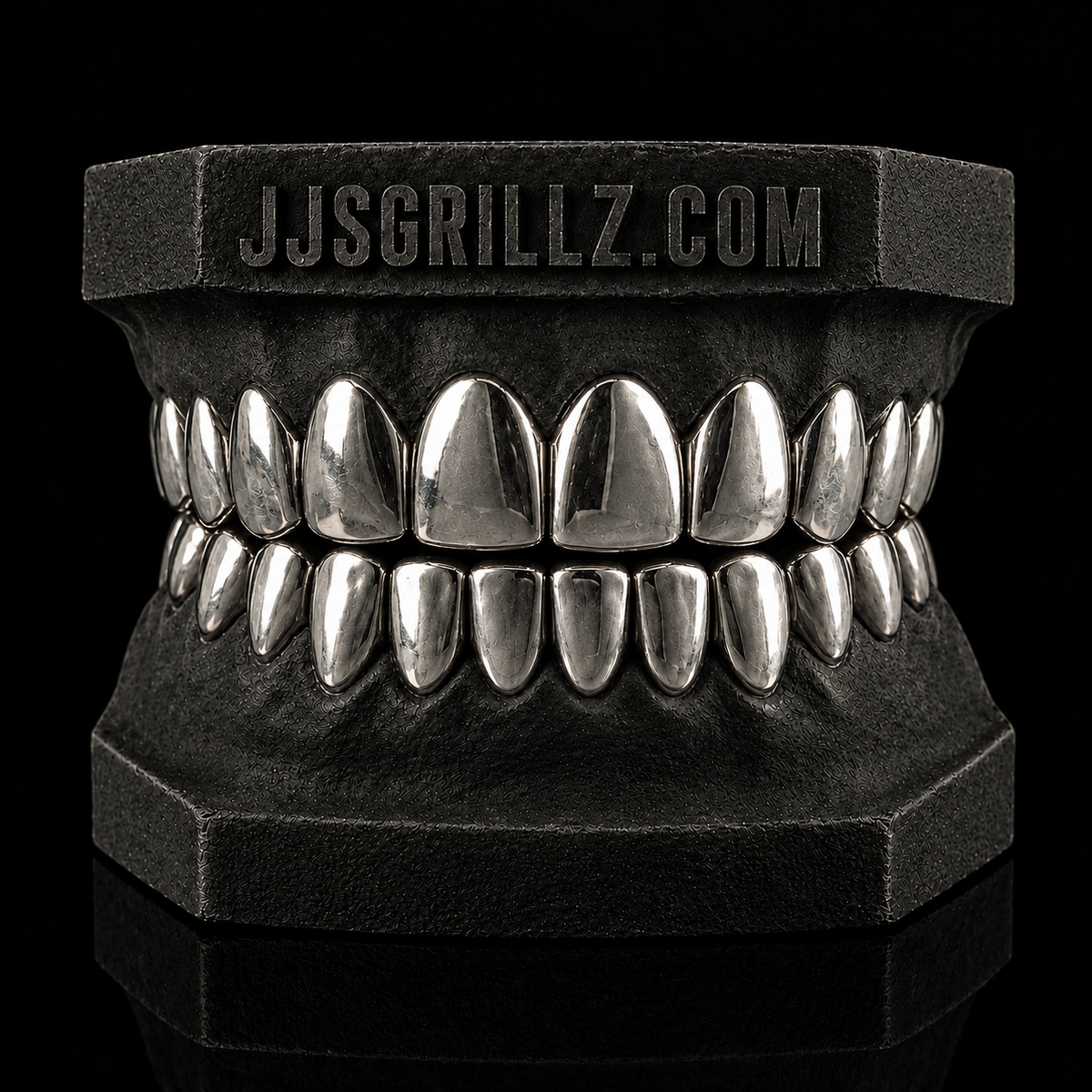 Custom .925 Sterling Silver Grillz by JJ’s Grillz displayed on a dental mould, showcasing the precision-fitted silver grillz design.