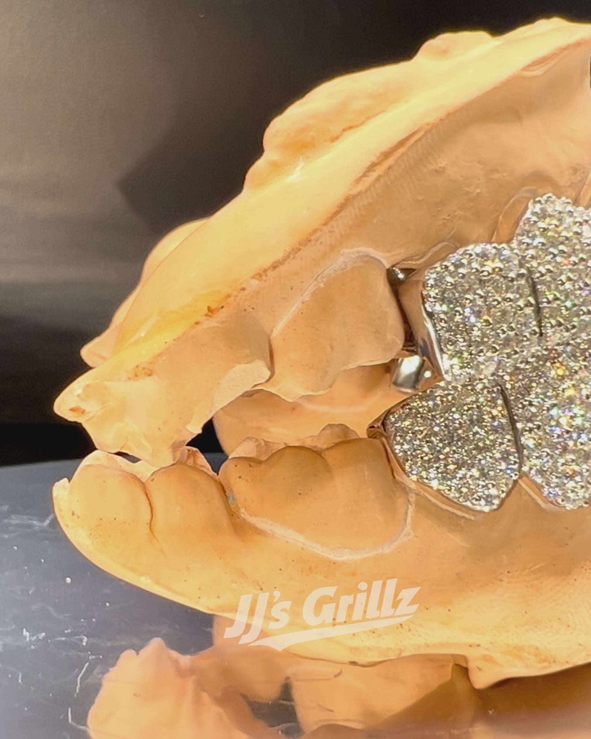 Luxury VVS Moissanite Grillz made by JJ's Grillz rotating on a 360 Display.