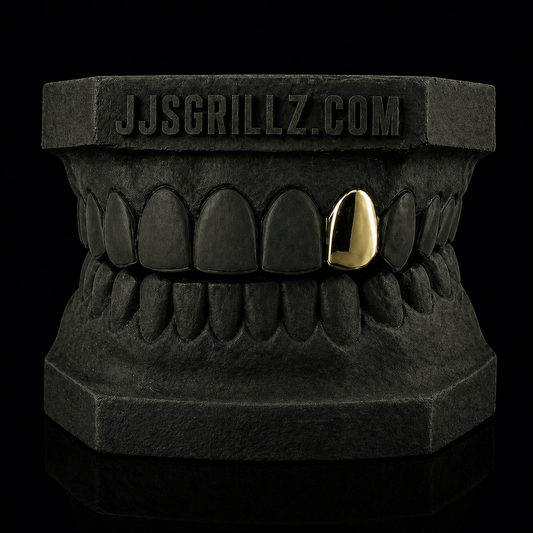 Custom Gold Tooth Cap on a black Custom Mould that features the brand 'JJSGRILLZ.COM' on it.